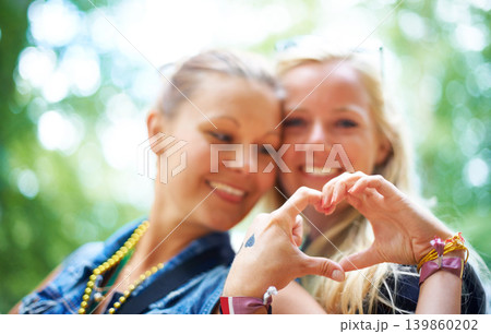 Friends, heart gesture and smile at festival to party, celebrate and summer in California for bonding, enjoy and entertainment. Event, outdoor and happiness at concert with music for enjoyment Friends, heart gesture and smile at festival to party, celebrate and summer in California for bonding, enjoy and entertainment. Event, outdoor and happiness at concert with music for enjoyment 139860202