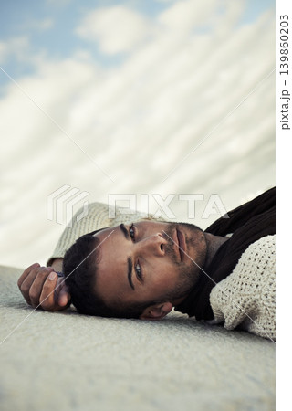 Fashion, sand or portrait of man in the desert for travel in summer to relax on holiday vacation. Wellness, male person or face of model on outdoor adventure with confidence or cool style in nature Fashion, sand or portrait of man in the desert for travel in summer to relax on holiday vacation. Wellness, male person or face of model on outdoor adventure with confidence or cool style in nature 139860203
