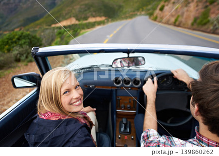 Couple, driving and convertible steering wheel on mountain from behind for vacation happy, adventure or holiday. Man, woman and portrait on transportation in California for travel, relax or nature Couple, driving and convertible steering wheel on mountain from behind for vacation happy, adventure or holiday. Man, woman and portrait on transportation in California for travel, relax or nature 139860262