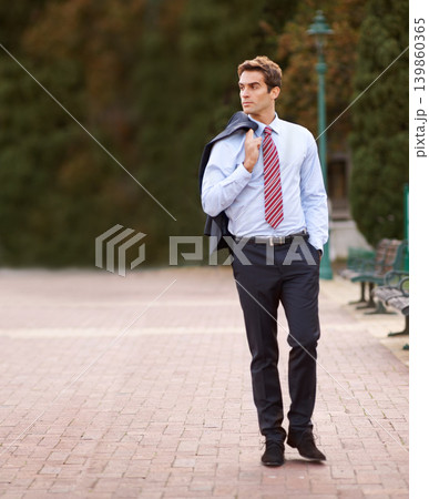 Jacket over his shoulder, business and man walking, park and professional with confidence. Person, outdoor and lawyer with a suit or fresh air with pose or entrepreneur with ideas, decision or choice Jacket over his shoulder, business and man walking, park and professional with confidence. Person, outdoor and lawyer with a suit or fresh air with pose or entrepreneur with ideas, decision or choice 139860365