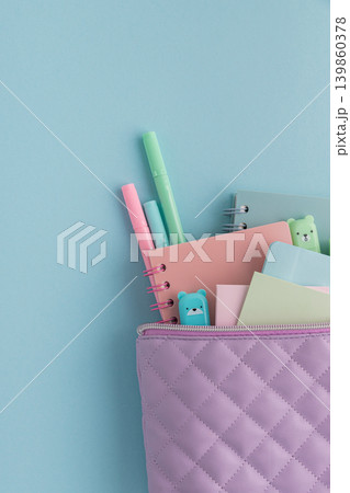Pastel school supplies filling a quilted pencil case 139860378