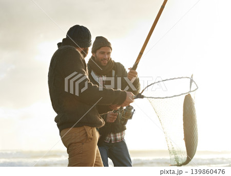 Fishing, men and net with fish at beach with rod, water and relax on vacation, holiday and travel. Friendship, people and bonding in morning with overcast, sky and nature for activity and hobby Fishing, men and net with fish at beach with rod, water and relax on vacation, holiday and travel. Friendship, people and bonding in morning with overcast, sky and nature for activity and hobby 139860476