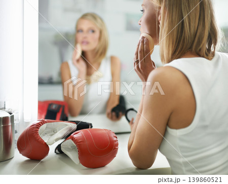 Female person, bruise and boxing gloves by mirror, makeup and stylish outfit in dressing room. Woman, blush and eyeshadow for sport match, reflection and fashion to prepare for post interview Female person, bruise and boxing gloves by mirror, makeup and stylish outfit in dressing room. Woman, blush and eyeshadow for sport match, reflection and fashion to prepare for post interview 139860521
