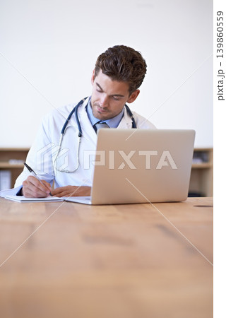 Doctor, laptop and notebook for writing at desk for medical research, schedule or patient report in office. Man, technology and pen on paper for results, planning or health insurance in hospital Doctor, laptop and notebook for writing at desk for medical research, schedule or patient report in office. Man, technology and pen on paper for results, planning or health insurance in hospital 139860559