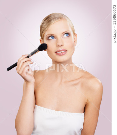 Makeup, brush and face of woman in studio with confidence, natural cosmetics or facial glow. Glamour, beauty and girl thinking on pink background with healthy skin shine, inspiration and wellness. 139860572