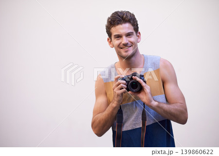 Man, camera and photographer in studio portrait, digital lens and tech for image or picture. Male person, hobby and equipment for photo on white background, mockup space and capture for memories 139860622