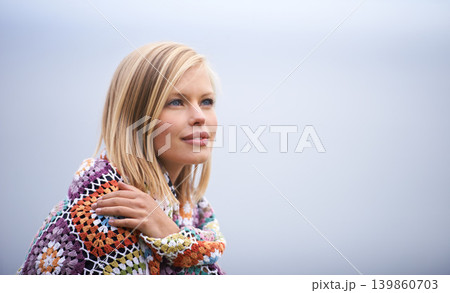 Thinking, clouds and woman with blanket in nature for adventure on holiday, vacation and weekend outdoors. Winter, travel and face of person for relaxing, happiness and peace in countryside for calm 139860703