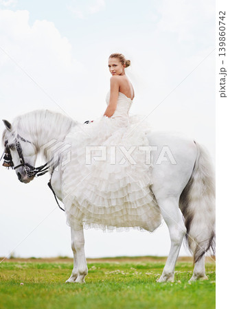 Wedding, woman and portrait with riding horse or happy for celebration, marriage and confidence in countryside. Bride, person and stallion on lawn in field with smile, dress and animal at ceremony Wedding, woman and portrait with riding horse or happy for celebration, marriage and confidence in countryside. Bride, person and stallion on lawn in field with smile, dress and animal at ceremony 139860742