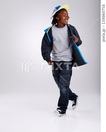 African boy, talent and dancing for fashion in studio for hiphop in backdrop of white background. Child, funky and happiness with smile of youth for kids clothes and mockup space with stylish person African boy, talent and dancing for fashion in studio for hiphop in backdrop of white background. Child, funky and happiness with smile of youth for kids clothes and mockup space with stylish person 139860758