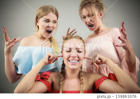 Woman being bullied by two females Woman being bullied by two females 139861076