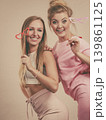 Two women holding carnival accessories 139861125