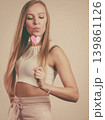 Happy woman holding heart on stick 139861126
