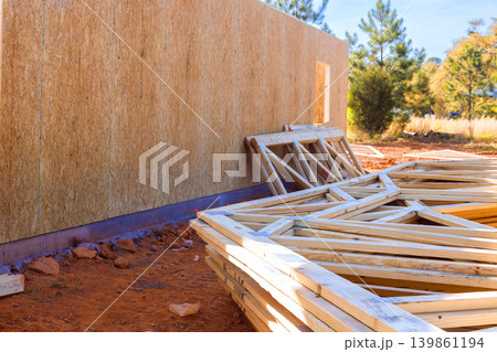 Wooden beams frames lay to wall at construction site in countryside 139861194