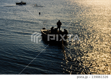 Fishermen set stationary nets at sunset Fishermen set stationary nets at sunset 139861326