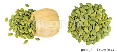Peeled pumpkin seeds in wooden bowl isolated on white background. Top view. Flat lay 139861633