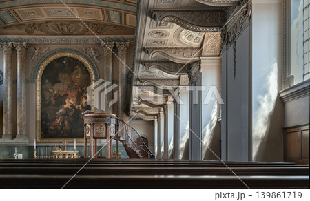 Viewed across dark wooden pews, the breathtaking altar of the Chapel of St Peter & St Paul unfolds in classical majesty. A grand altarpiece painting is framed by soaring Corinthian columns and an Viewed across dark wooden pews, the breathtaking altar of the Chapel of St Peter & St Paul unfolds in classical majesty. A grand altarpiece painting is framed by soaring Corinthian columns and an 139861719