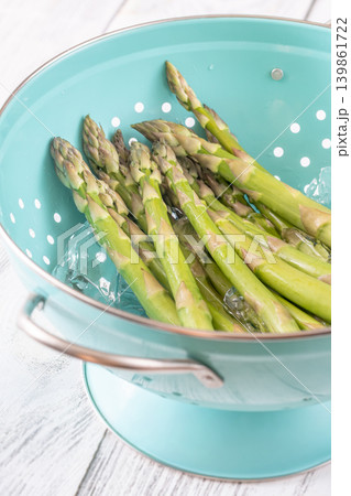 Fresh Green Asparagus Chilling In Ice Water During Blanching Preparation Process Fresh Green Asparagus Chilling In Ice Water During Blanching Preparation Process 139861722