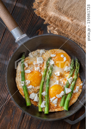 Rustic Breakfast Skillet With Fried Eggs Asparagus And Feta Cheese 139861728