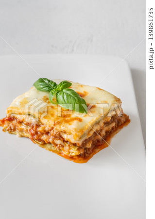 Classic Lasagna Bolognese Slice With Golden Mozzarella And Fresh Basil Garnish Classic Lasagna Bolognese Slice With Golden Mozzarella And Fresh Basil Garnish 139861735