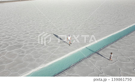 Aerial view of father and child playing football on white salt flats Salinas Jujuy Argentina 139861750