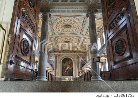 the majestic interior of the chapel opens into a breathtaking vista of neoclassical grandeur. Stately fluted columns frame the central nave, guiding the eye toward an illuminated altar painting while the majestic interior of the chapel opens into a breathtaking vista of neoclassical grandeur. Stately fluted columns frame the central nave, guiding the eye toward an illuminated altar painting while 139861753