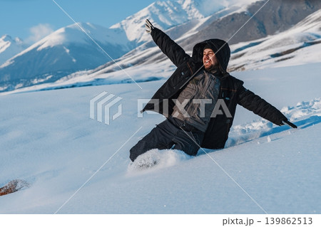 Young man tourist sliding down from mountain at winter season Young man tourist sliding down from mountain at winter season 139862513