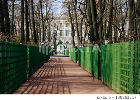 people stroll through the summer garden on a sunny May morning, Russia, St.Petersburg, alleys of trees and statues, the Fontanka River embankment with a view of the engineering castle people stroll through the summer garden on a sunny May morning, Russia, St.Petersburg, alleys of trees and statues, the Fontanka River embankment with a view of the engineering castle 139862517