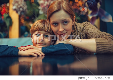 Mother and child sitting in caffe portrait 139862686