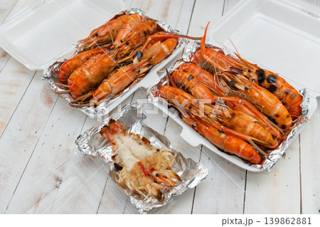 Fresh grilled river prawns served takeaway containers wooden table seafood street food meal ready to eat Fresh grilled river prawns served takeaway containers wooden table seafood street food meal ready to eat 139862881