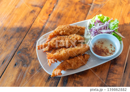 Golden crispy fried shrimp served dipping sauce fresh salad wooden table delicious seafood appetizer ready to eat Golden crispy fried shrimp served dipping sauce fresh salad wooden table delicious seafood appetizer ready to eat 139862882