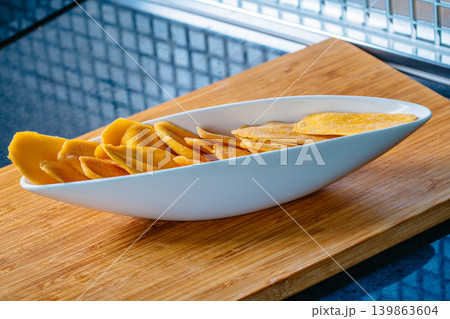 Kitchen table with dried mango in bowl Kitchen table with dried mango in bowl 139863604