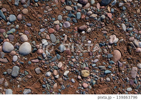 Small stones on dried riverbed Small stones on dried riverbed 139863796