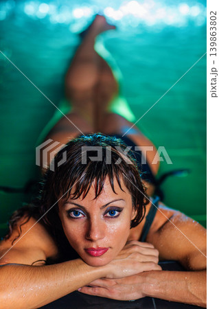 Young woman in pool portrait Young woman in pool portrait 139863802