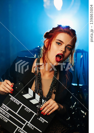 Young woman portrait with cinema clapper Young woman portrait with cinema clapper 139863804