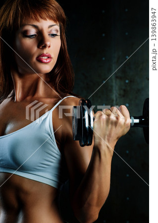 Young sports woman with dumbbell portrait Young sports woman with dumbbell portrait 139863947