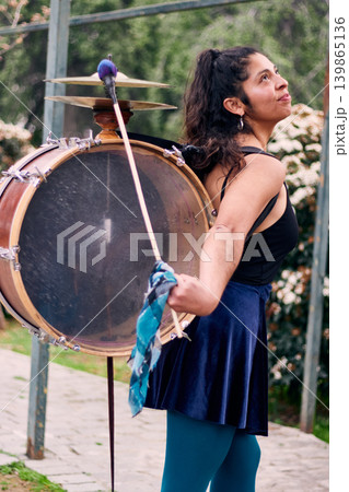Detail of a musical instrument, bass drum and cymbals belonging to a chinchinera, a female street musician who dances and plays her drum in the streets. Chilean heritage, Chilean culture Detail of a musical instrument, bass drum and cymbals belonging to a chinchinera, a female street musician who dances and plays her drum in the streets. Chilean heritage, Chilean culture 139865136