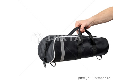 mens hand holds black case by handles isolated on white background mens hand holds black case by handles isolated on white background 139865642