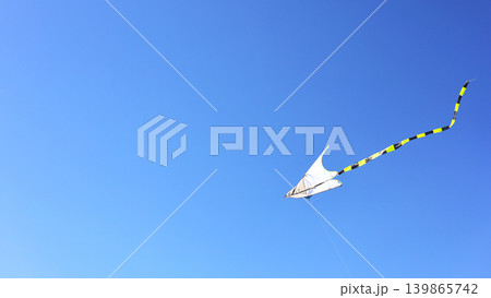 White Kite Flying High In Blue Sky 139865742