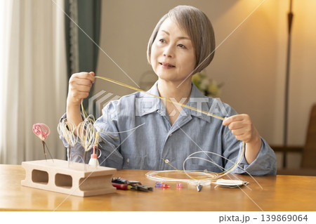 水引で髪飾りを作るシニア女性 水引で髪飾りを作るシニア女性 139869064