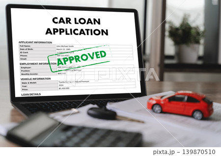 Approved car loan application form displayed on laptop with vehicle model, calculator, car key, and financial documents for online financing, banking approval, and credit verification. 139870510