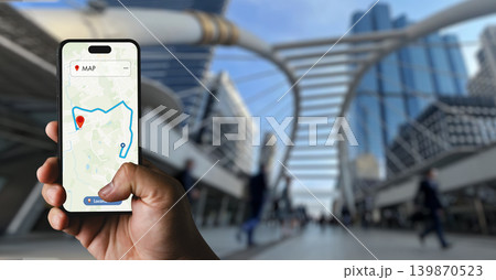 Hand holding smartphone displaying GPS map route in modern urban street environment, suitable for mobile navigation, destination tracking, location connection, and digital map application concepts. Hand holding smartphone displaying GPS map route in modern urban street environment, suitable for mobile navigation, destination tracking, location connection, and digital map application concepts. 139870523
