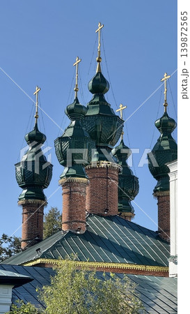 Orthodox church with green onion domes against clear blue sky 139872565