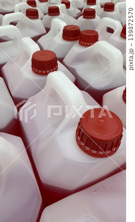 Red and white plastic jerrycans arranged in pattern creating abstract background Red and white plastic jerrycans arranged in pattern creating abstract background 139872570