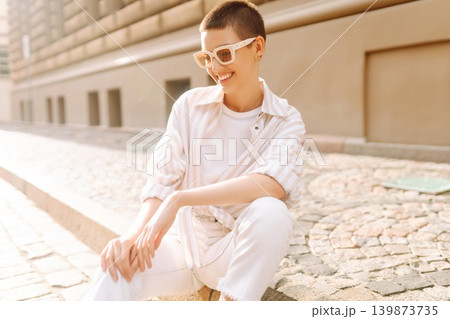 Beautiful woman in stylish clothes and short hair poses. Minimalism, urban style clothes. Beautiful woman in stylish clothes and short hair poses. Minimalism, urban style clothes. 139873735