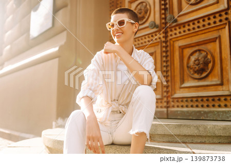 Beautiful woman in stylish clothes and short hair poses. Minimalism, urban style clothes. 139873738
