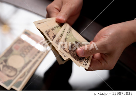 お金を数える男性 手元 お金を数える男性 手元 139873835