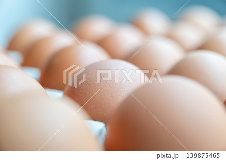 Fresh organic brown chicken eggs in cardboard tray Fresh organic brown chicken eggs in cardboard tray 139875465