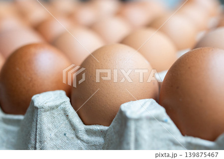Fresh organic brown chicken eggs in cardboard tray Fresh organic brown chicken eggs in cardboard tray 139875467