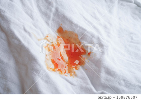 Dirty tomato sauce stain or ketchup on cloth to wash with washing powder, cleaning housework. Dirty tomato sauce stain or ketchup on cloth to wash with washing powder, cleaning housework. 139876307