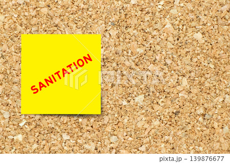 Yellow note paper with word sanitation on cork board background with copy space Yellow note paper with word sanitation on cork board background with copy space 139876677